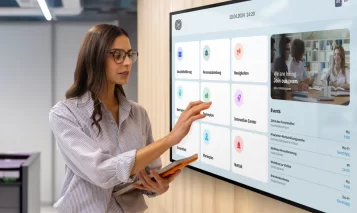 A person with a digital noticeboard